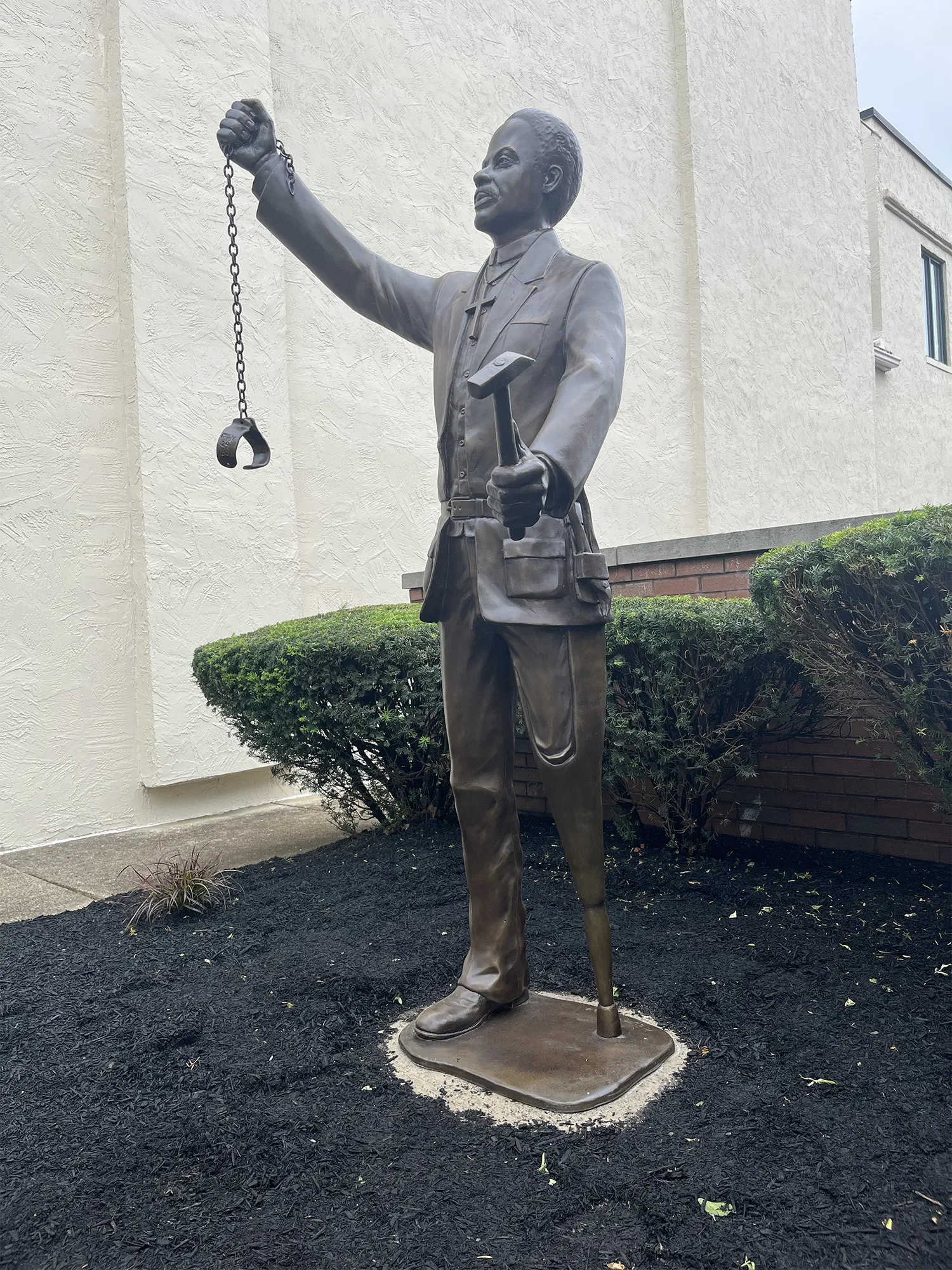Detail of the Scipio Smith statue showing his tinsmith tools